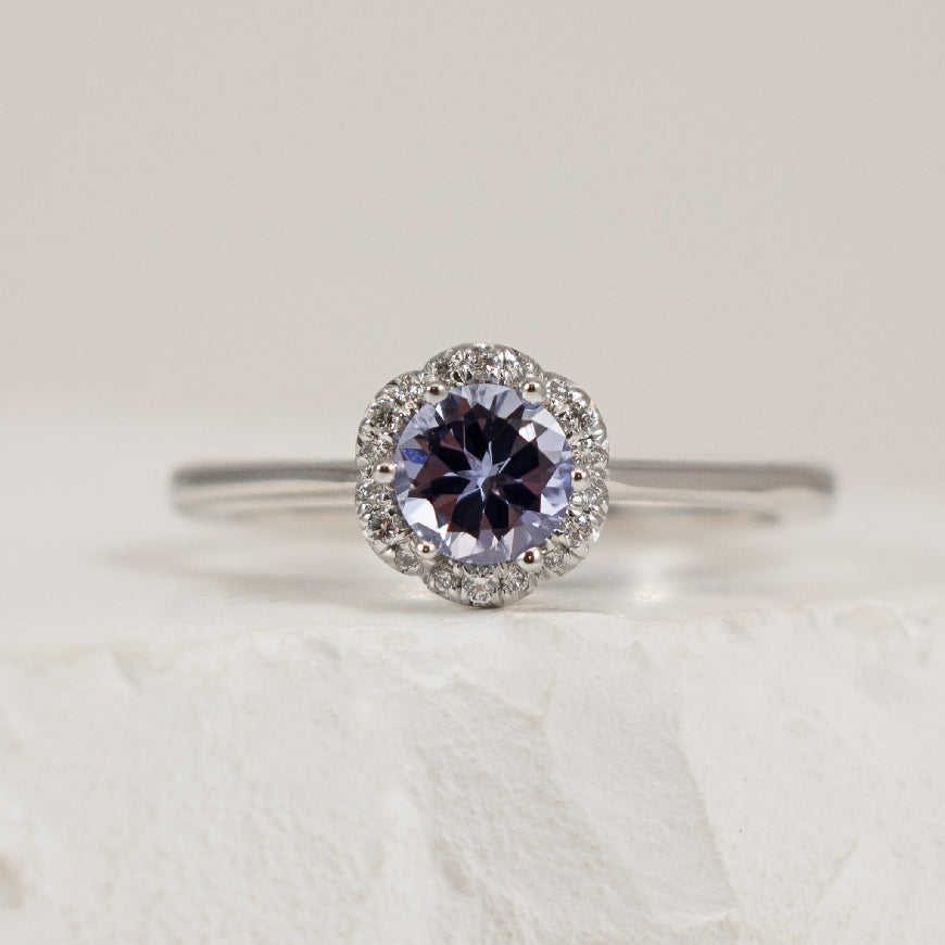 18KW Vintage Style Halo 0.52 Carat Sapphire Ring 

Center - 0.52 Carat Purple-Blue Sapphire 

0.08 Carats Round Brilliant Cut Natural Diamonds  

Band Width 2.4mm

Finger Size 6 