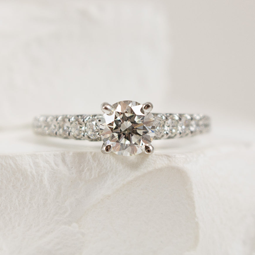 18K White Gold Diamond Accented Engagement Ring Setting 

Center Diamond - To Hold a 0.90CT RBC 

Accent Diamonds - 1.13 Carats Round Brilliant Cut Diamonds of SI1 Clarity, G-H Colour

1.13Total Diamond Weight 

Band Width 1.9mm

Finger Siz
