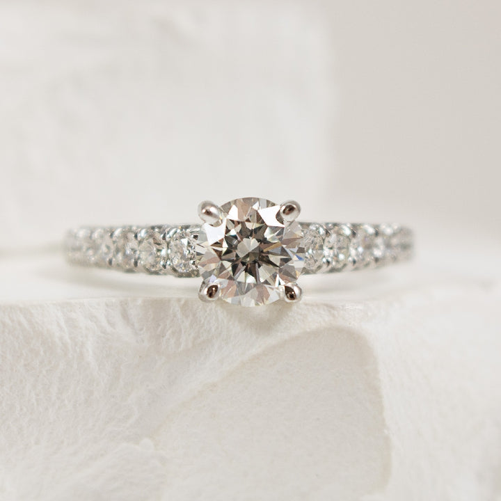 18K White Gold Diamond Accented Engagement Ring Setting 

Center Diamond - To Hold a 0.90CT RBC 

Accent Diamonds - 1.13 Carats Round Brilliant Cut Diamonds of SI1 Clarity, G-H Colour

1.13Total Diamond Weight 

Band Width 1.9mm

Finger Siz