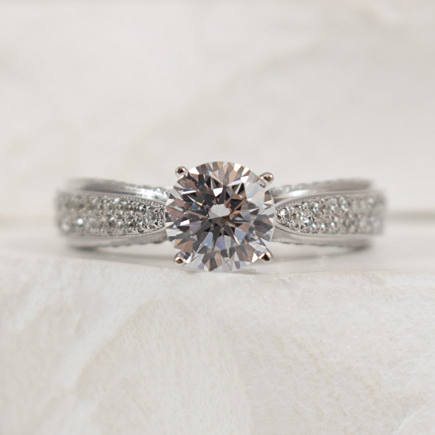 14K White Gold Diamond Accented Ring Setting

Center - To Hold 1.00CT Round Brilliant Cut Diamond

Accent - 0.55 Total Natural Diamond Weight of I1 Clarity, GH Colour

Finger Size 6.5

*Price for ring only. This ring can be set with your choi