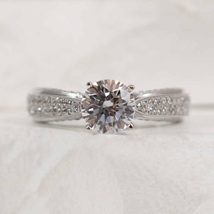 14K White Gold Diamond Accented Ring Setting

Center - To Hold 1.00CT Round Brilliant Cut Diamond

Accent - 0.55 Total Natural Diamond Weight of I1 Clarity, GH Colour

Finger Size 6.5

*Price for ring only. This ring can be set with your choi