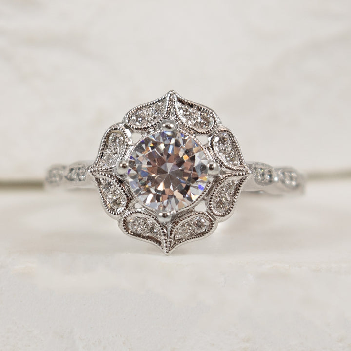 14K White Gold Diamond Accented Vintage Halo Ring Setting

Center - To Hold 0.70CT Round Brilliant Cut Diamond

Accent - 0.13 Total Natural Diamond Weight of SI1 Clarity, H Colour

Finger Size 6.75 

*Price for ring only. This ring can be set