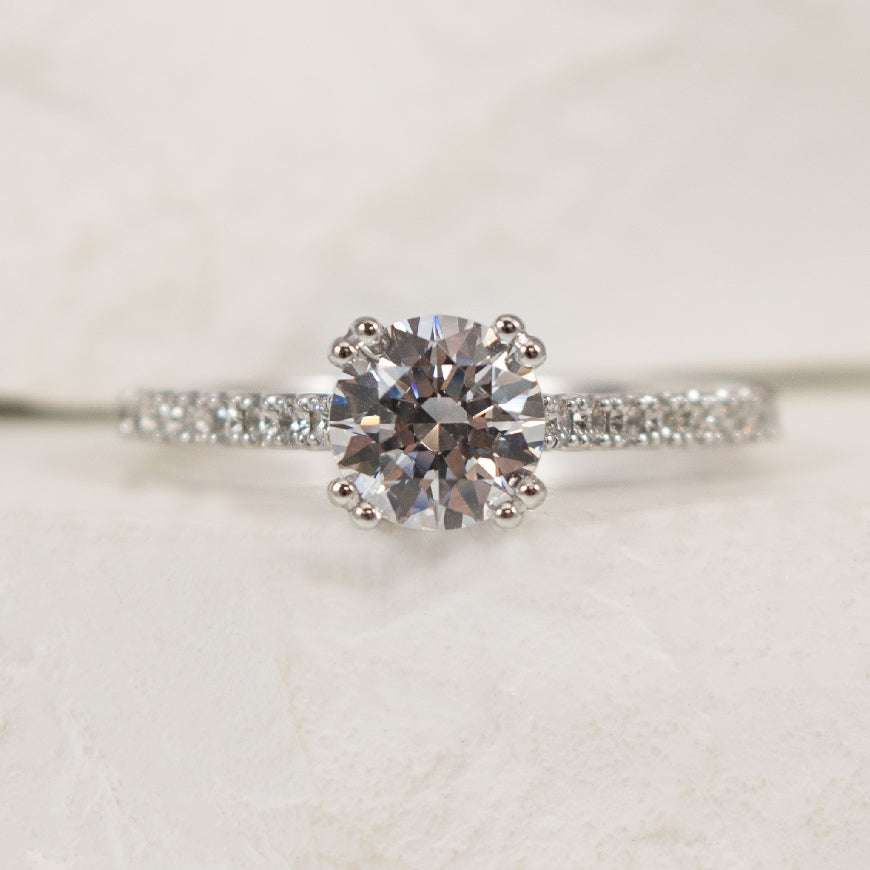 18K White Gold Diamond Accented Ring Setting

Center - To Hold 1.00CT Round Brilliant Cut Diamond

Accent - 0.33 Total Natural Diamond Weight of SI1 Clarity, G Colour

Finger Size 6.5 

*Price for ring only. This ring can be set with your cho