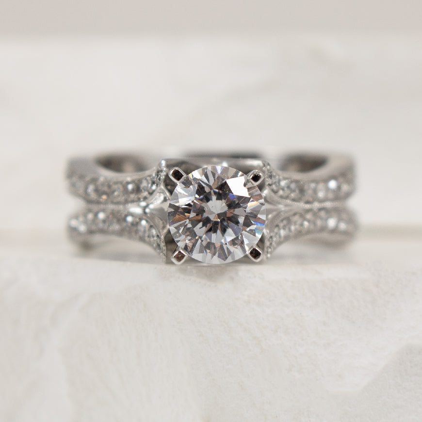 14K White Gold Diamond Accented Ring Setting

Center - To Hold 1.00CT Round Brilliant Cut Diamond 

Accent - 0.51 Total Natural Diamond Weight of I1 Clarity, GH Colour

Finger Size 6.5 

*Price for ring only. This ring can be set with your ch