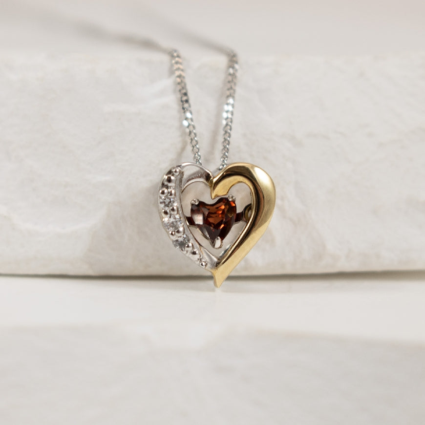 10K White & Yellow Gold Garnet & Diamond Heart Pulse Necklace 

0.02 Total Natural Diamond Weight 

Chain Length 18'

