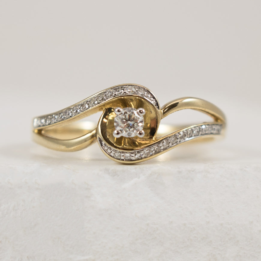 10K Yellow Gold Natural Diamond Open Twist Engagement Ring 

0.08 Carat Round Brilliant Cut Diamond

0.17 Total Natural Diamond Weight 

Finger Size 