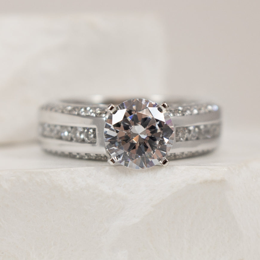 14K White Gold Diamond Accented Ring Setting 

Center - To Hold 1.25CT Round Brilliant Cut Diamond 

Accent - 0.85 Total Natural Diamond Weight of I1 Clarity, GH Colour

Finger Size 6.5

*Price for ring only. This ring can be set with your ch