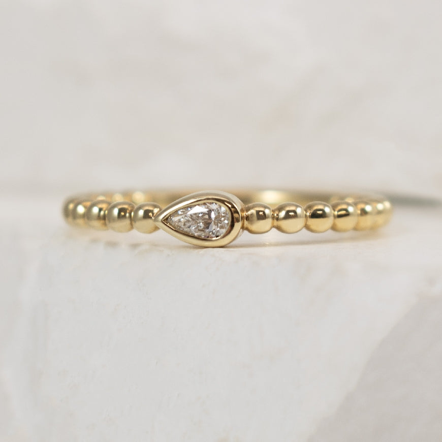 10KY Pear Shaped Diamond Beaded Ring              

10K Yellow Gold Natural Pear Shaped Diamond Beaded Ring

0.10 Carat of Natural Pear Shaped Diamond I1 Clarity, GH Colour

Finger Size 6.25

