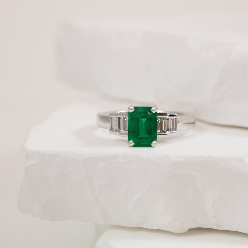 18KW Emerald Cut Emerald & Diamond Accented Ring   

18K White Gold Emerald & Natural Diamond Ring

1.06 Carat Emerald Cut Emerald
0.56 Total Natural Diamond Weight SI Clarity, GH Colour

Finger Size 6.5

