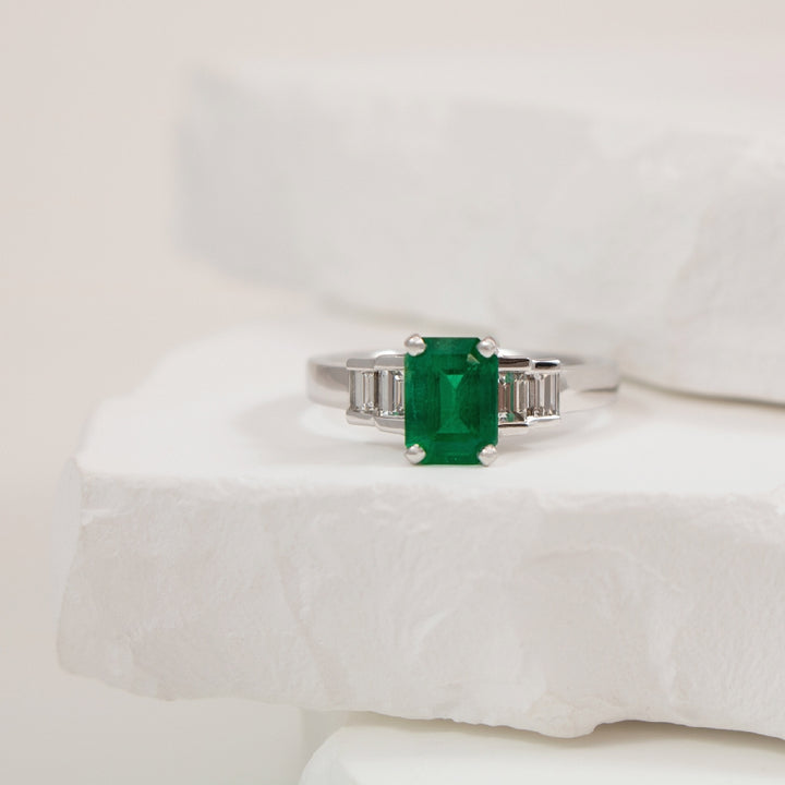 18KW Emerald Cut Emerald & Diamond Accented Ring   

18K White Gold Emerald & Natural Diamond Ring

1.06 Carat Emerald Cut Emerald
0.56 Total Natural Diamond Weight SI Clarity, GH Colour

Finger Size 6.5

