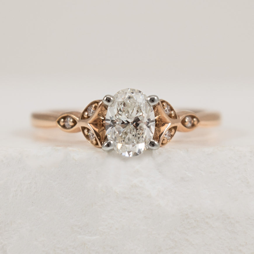 14K Rose Gold Natural Diamond Oval Cut Leafy Engagment Ring

Center Diamond - 0.70 Carat Oval Cut Natural Diamond of SI1 Clarity, G Colour, Excellent/ Excellent/ Very Good Cut, GIA Certified 

Accent Diamonds - 0.06 Carats Round Brilliant Cut Nat