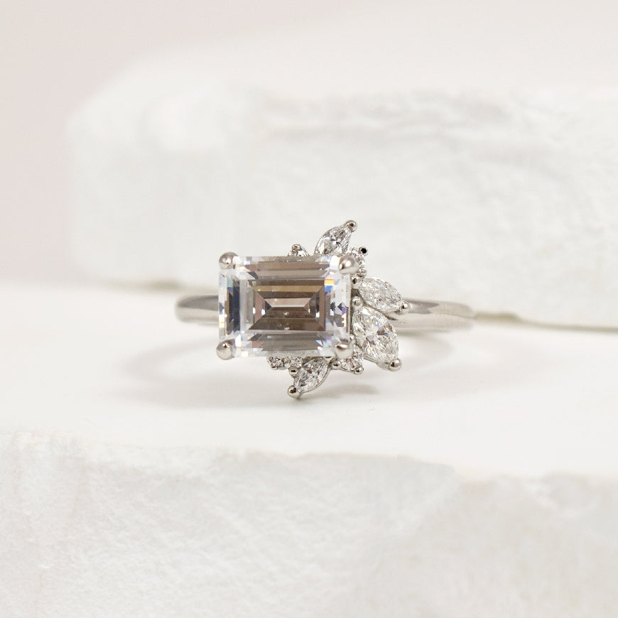 Platinum East-West Diamond Engagement Ring Setting

Platinum East-West Set Diamond Accented Engagement Ring Setting

Center - To Hold 8X6MM Emerald Cut Diamond

Accent - 0.33 Carats of Natural Diamonds of SI2-3 Clarity, GHI Colour

Band Width