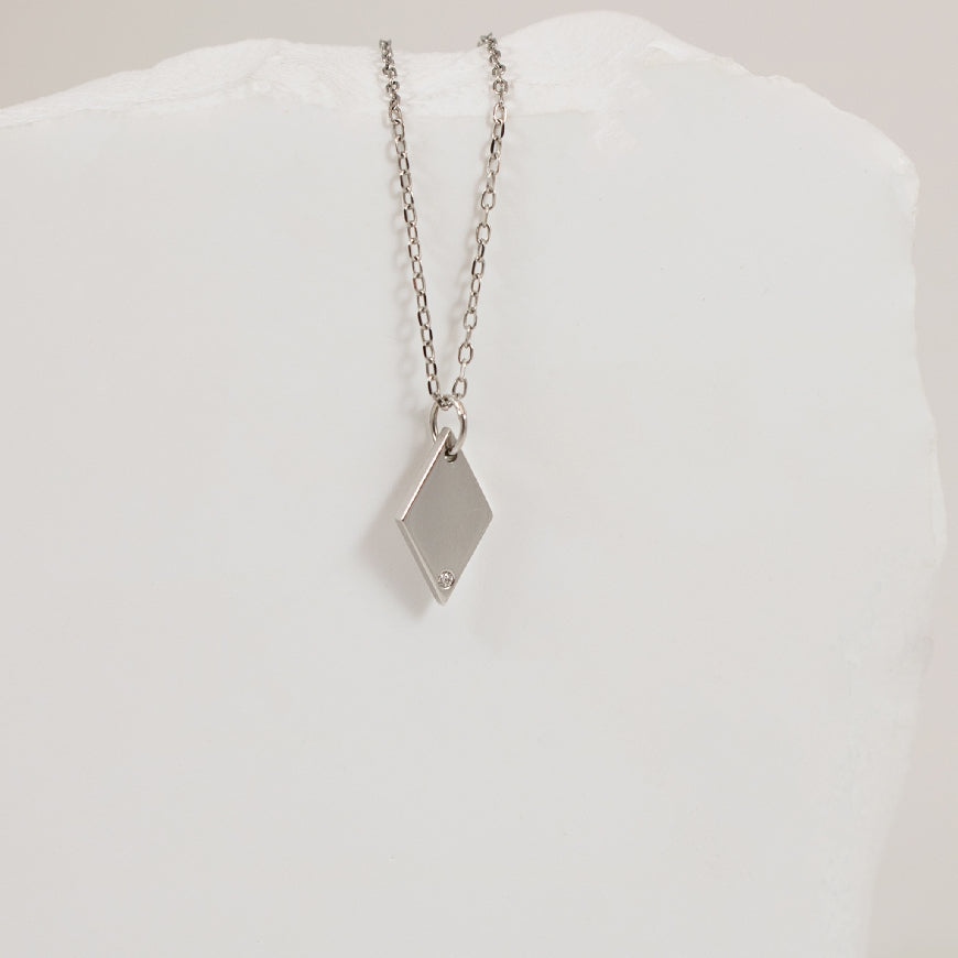 14KW Diamond Rhombus Pendant                      

14K White Gold Natural Diamond Rhombus Pendant 

0.005 Total Natural Diamond Weight I1 Clarity, GH Colour

*Chain not included*

