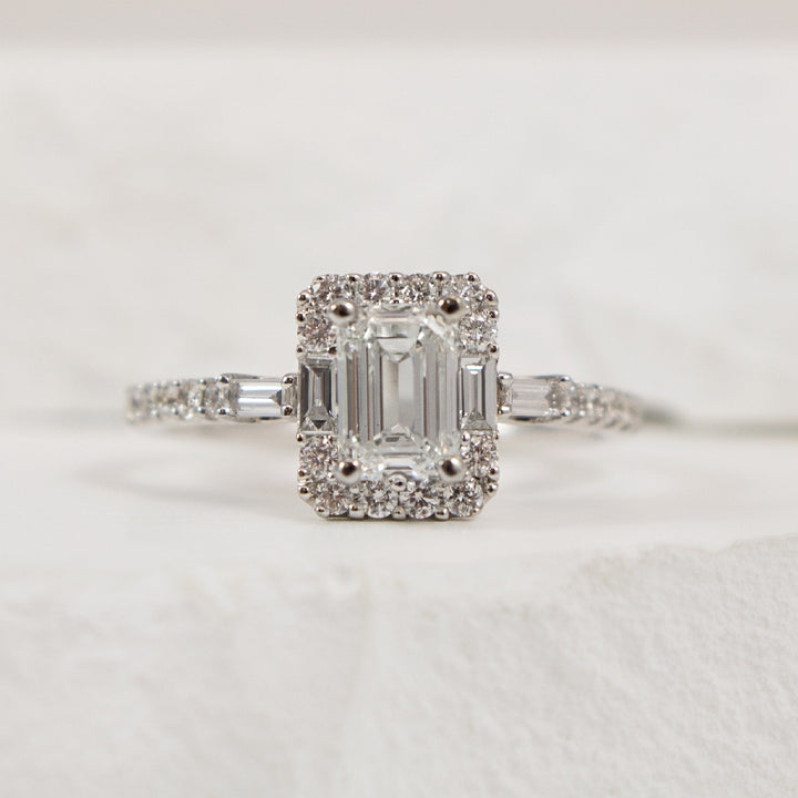 14KW Emerald Cut Halo Diamond Engagement Ring     

14K White Gold Canadian Natural Diamond Emerald Cut Halo Engagement Ring 

Center - 0.90 Carat Emerald Cut Canadian Natural Diamond of VS1 Clarity, H Coloue, Very Good Cut 
 
Accent - 0.45 Car