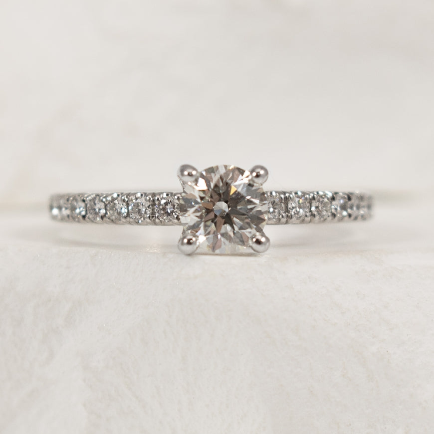 18K White Gold Forevermark Natural Diamond Accented Engagement Ring 

Center - 0.53 Carat Forevermark Round Brilliant Cut Natural Diamond of VS1 Clarity, H Colour, Black Label (Ideal) Cut, Forevermark Certified  

Accent - 0.36 Carats Round Brill