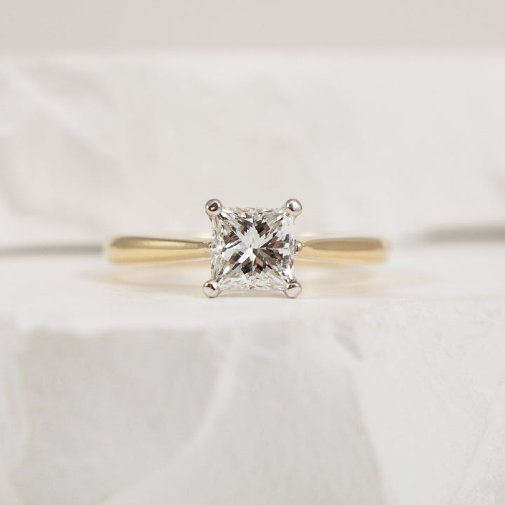 14KY Solitaire 1.00CT Princess Cut Engagement Ring

14K Yellow & White Gold Natural Diamond Princess Cut Solitaire Diamond Engagement Ring

Center Diamond - 1.00 Carat Princess Cut Natural Diamond of SI2 Clarity, G Colour, Excellent/ Good Cut, GI