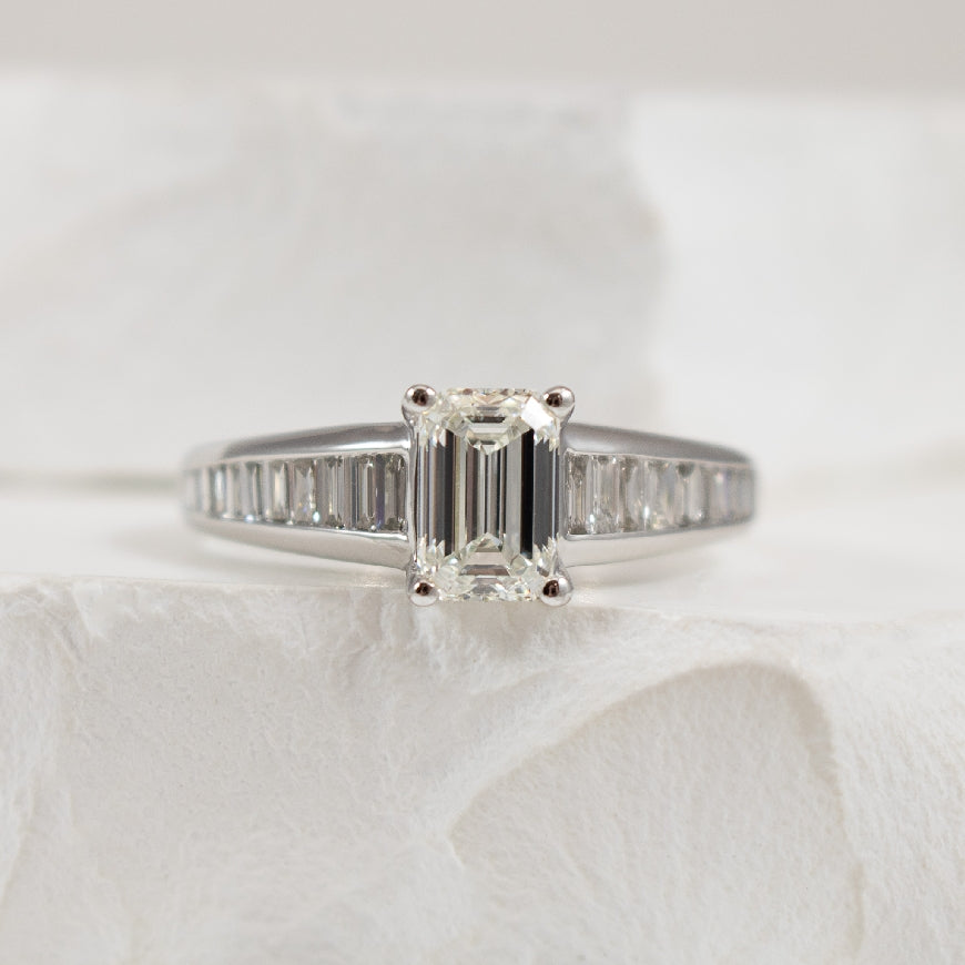 14K White Gold Forevermark Natural Diamond Emerald & Baguette Cut Accented Engagement Ring 

Center - 1.00 Carat Emeral Cut Forevermark Natural Diamond of VVS2 Clarity, H Colour, Excellent/ Excellent Cut, Forevermark Certified 

Accent - 0.50 Car