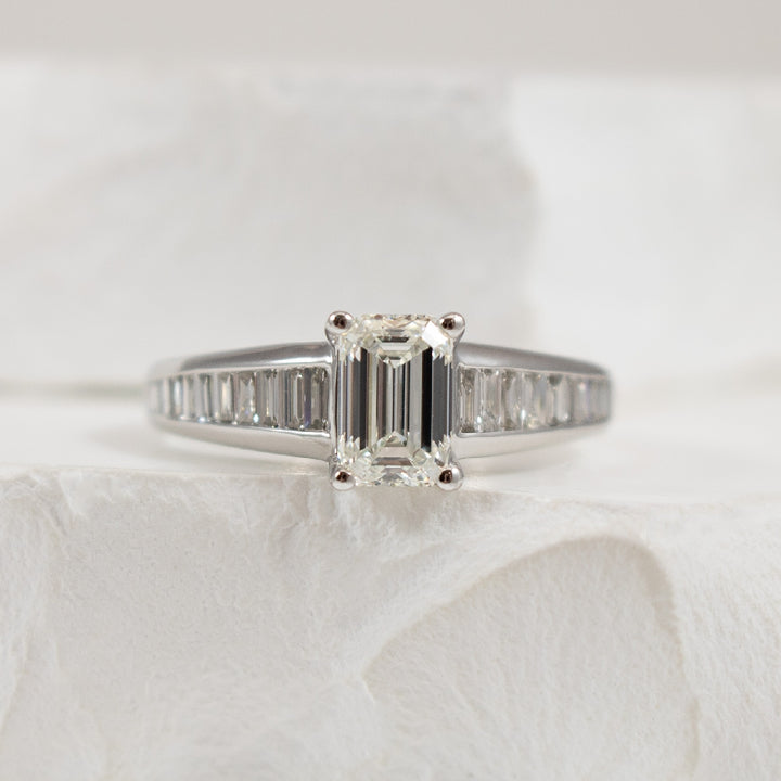 14K White Gold Forevermark Natural Diamond Emerald & Baguette Cut Accented Engagement Ring 

Center - 1.00 Carat Emeral Cut Forevermark Natural Diamond of VVS2 Clarity, H Colour, Excellent/ Excellent Cut, Forevermark Certified 

Accent - 0.50 Car