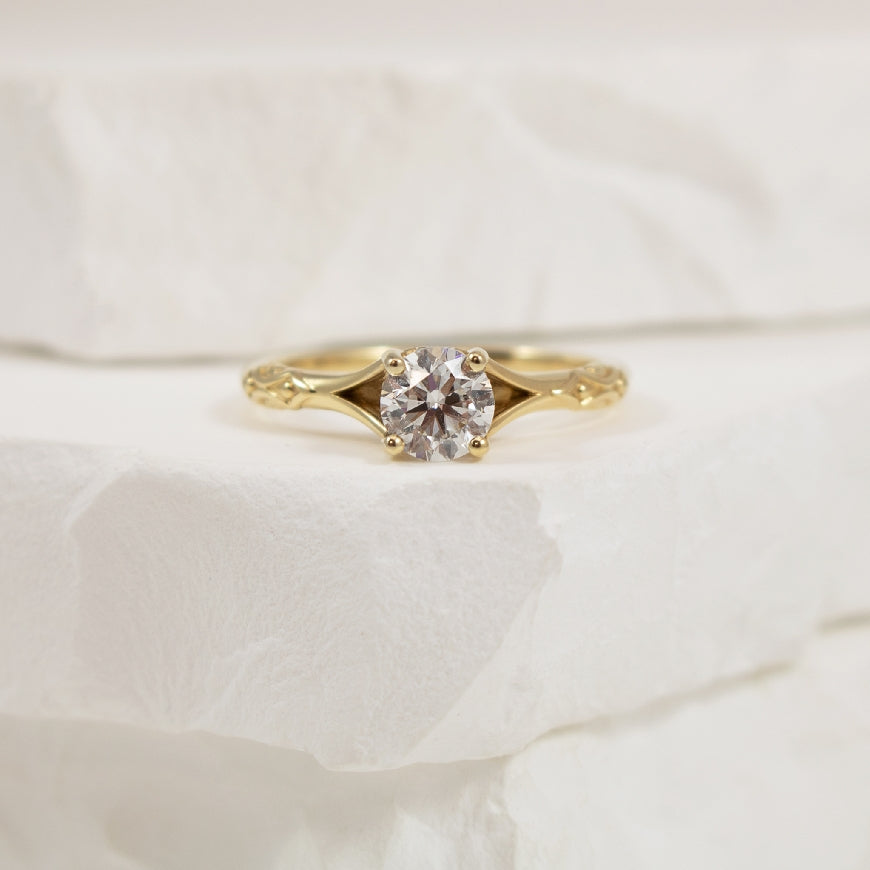 14KY Solitaire 0.72CT Vintage Style Engagement Ring

14K Yellow Gold Solitaire Natural Diamond Vintage Style Engagement Ring 

Center - 0.72CT Round Brilliant Cut Diamond of SI2 Clarity, H Colour, Very Good Cut

Band Width 1.8mm

Finger Size 