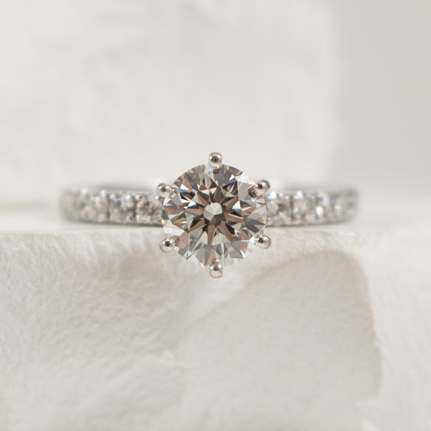 14K White Gold Roman & Jules Forevermark Natural Diamond Accented 6 Claw Engagement Ring 

Center - 1.05 Carat Round Brilliant Cut Lab Grown Diamond of VVS2 Clarity, E Colour, Ideal/ Excellent/Excellent Cut

Accent - 0.48 Carats Round Brilliant C