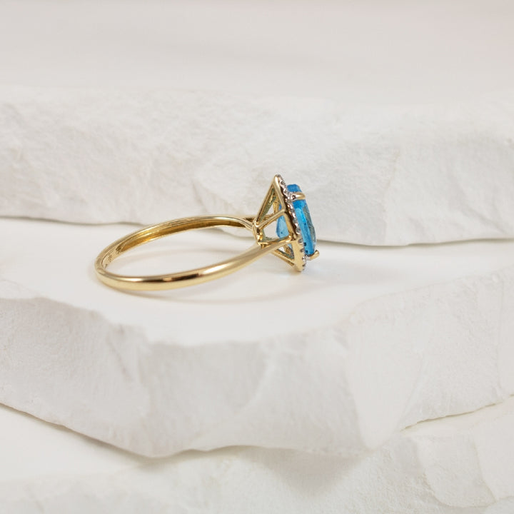 10KY Pear Shaped Blue Topaz & Diamond Halo Ring
