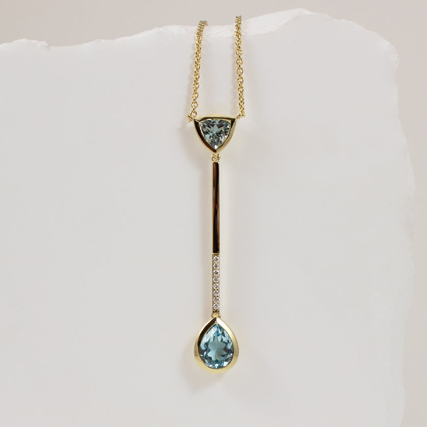 14KY Modern Blue Topaz & Diamond Drop Necklace     

14K Yellow Gold Breuning Blue Topaz & Natural Diamond Necklace

0.06 Total Natural Diamonds SI Clarity, H Colour

Chain Length 18' (Adujustable to 17')

