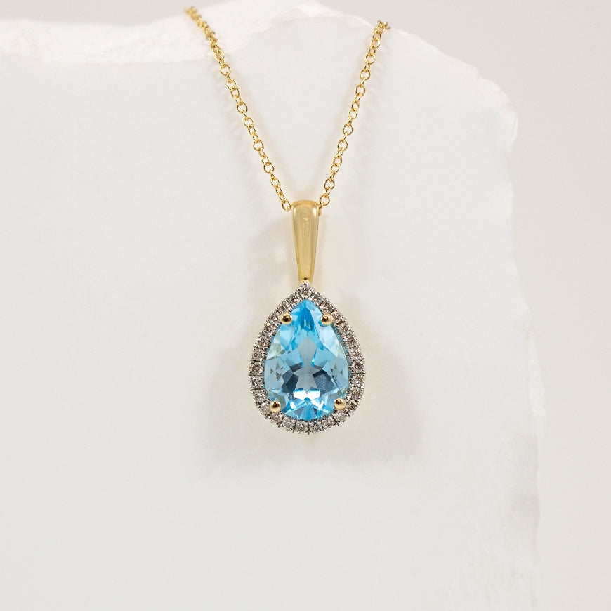 10KY Pear Shape Blue Topaz & Diamond Halo Necklace 

10K Yellow Gold Blue Topaz & Natural Diamond Necklace

0.135 Total Natural Diamond Weight

Chain Length  '
