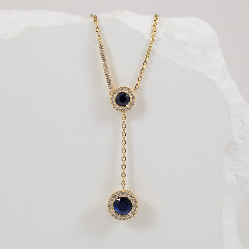 14KY Sapphire & Diamond Halo Lariat Drop Necklace 

14K Yellow Gold Sapphire & Natural Diamond Necklace

0.45 Total Sapphire Weight

0.12 Total Natural Diamond Weight SI Clarity, GH Colour

Chain Length 18' (Adjustable to 16' or 17')
