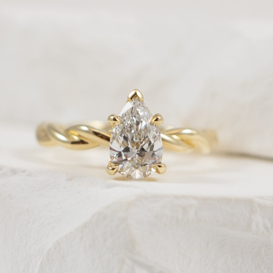 14KY Twisted Solitaire Diamond Engagement Ring    

14K Yellow Gold Gabriel & Co. Pear Shaped Lab Grown Diamond Solitaire Twist Ring 

Center Diamond -  1.01 Carat Pear Shaped Lab Grown Diamond  VS1 Clarity, D Colour, Excellent/ Excellent Cut

