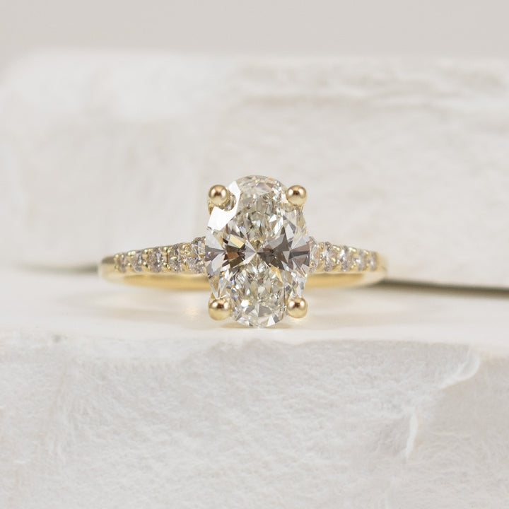 14KY Oval Cut Graduated Diamond Engagement Ring   

14K Yellow Gold Gabriel & Co. Lab Grown & Natural Diamond Accented Engagement Ring

Center - 0.92 Carat Oval Cut Lab Grown Diamond of VVS2 Clarity, E Colour, Excellent/ Excellent Cut 

Accent 