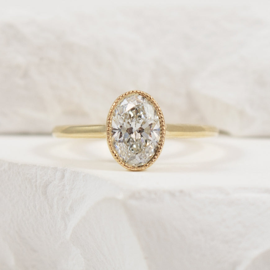 14KY 1.03CT Oval Cut Bezel Diamond Engagement Ring       

14K Yellow Gold Lab Grown Diamond Solitaire Milgrain Bezel Engagement Ring 

Center - 1.03 Carat Oval Cut Lab Grown Diamond of VVS2 Clarity, E Colour, Excellent Cut, CGL Certified 

Ban