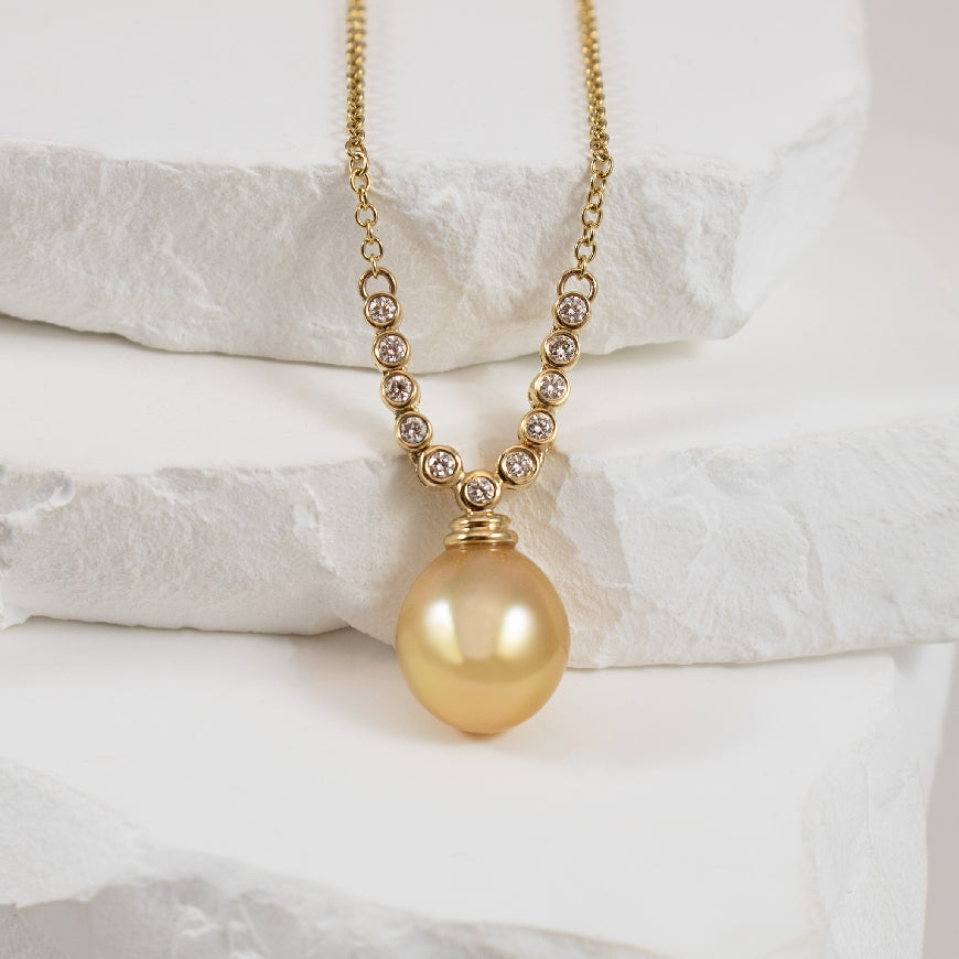 14KY Golden South Sea Pearl & Diamond Necklace    

14K Yellow Gold Golden South Sea Pearl & Natural Diamond Drop Necklace 

11-12mm South Sea Golden Pearl 

0.23 Total Natural Diamond Weight of SI1-2 Clarity, GH Colour

Necklace Length 16'