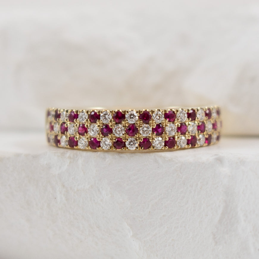 14KY Ruby & Diamond Checkered Pattern Ring                      

14K Yellow Gold Ruby & Diamond Ring 

0.39 Carats of Rubies 

0.36 Carat Total Diamond Weight of SI1-2 Clarity, GH Colour 

4.5mm Wide 

Finger Size 6.5 