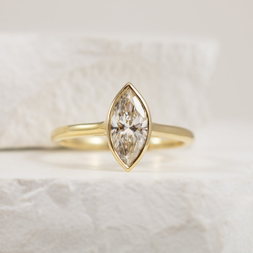 14KY Bezel Marquise Cut Diamond Engagement Ring      

14K Yellow Gold Lab Grown Bezel Set Marquise Diamond Solitaire Engagement Ring 

Center - 1.01CT Marquise Cut Lab Grown Diamond of VS1 Clarity, E Colour, Excellent/Excellent Cut, IGI Certifie
