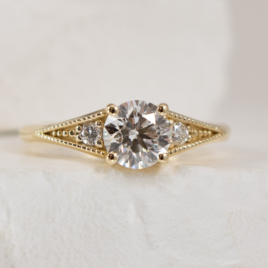 14KY Vintage Millgrain Diamond Engagement Ring

14K Yellow Gold Lab Grown & Natural Diamond Vitange Millgrain Engagement Ring 

Center - 0.90CT Round Brilliant Cut Lab Grown Diamond VS2 Clarity, D Colour, Ideal/ Excellent/ Excellent Cut, IGI Cert