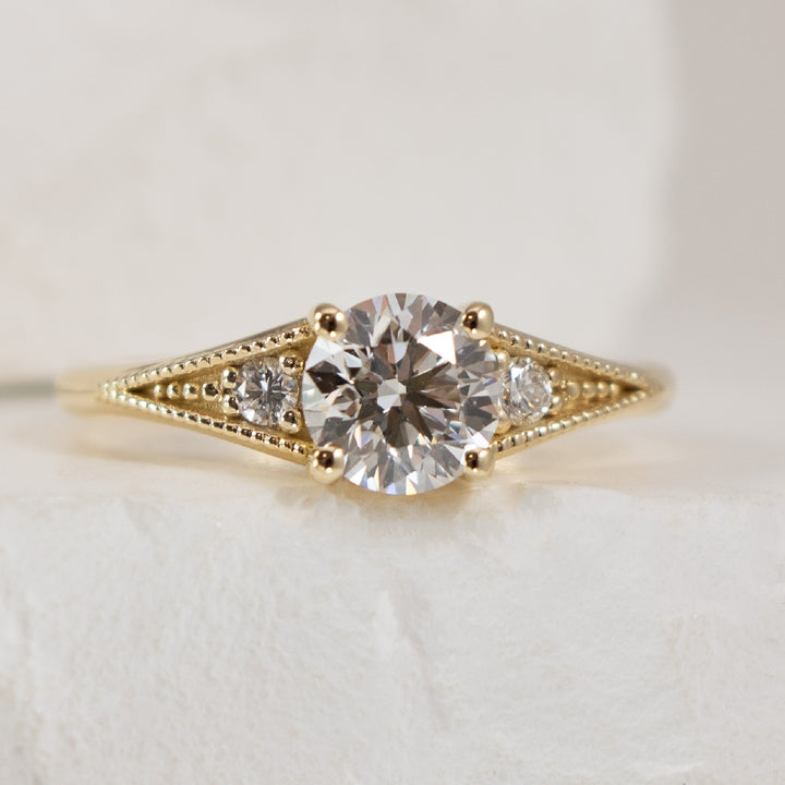 14KY Vintage Millgrain Diamond Engagement Ring

14K Yellow Gold Lab Grown & Natural Diamond Vitange Millgrain Engagement Ring 

Center - 0.90CT Round Brilliant Cut Lab Grown Diamond VS2 Clarity, D Colour, Ideal/ Excellent/ Excellent Cut, IGI Cert