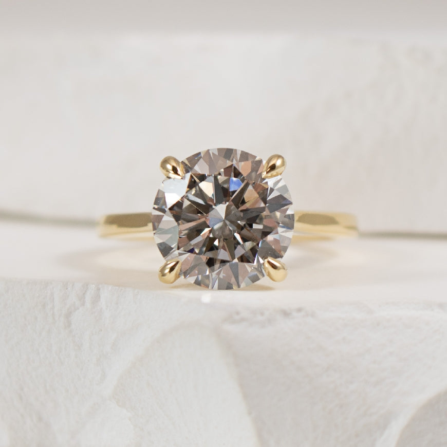 14K Yellow Gold Gabriel & Co Lab Grown & Natural Diamond Engagement Ring 

Center - 4.05CT Round Brilliant Cut Lab Grown Diamond of VVS2 Clarity, E Colour, Excellent/ Excellent/Excellent Cut, IGI Certified 

Accent - 0.15 Total Natural Diamond We