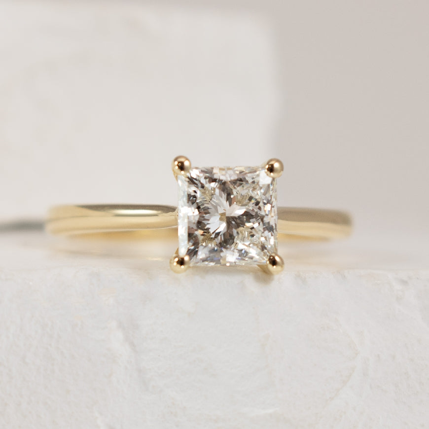 14KY Princess Cut 1.26CT Diamond Engagement Ring  

14K Yellow Gold Princess Cut Lab Grown Diamond Solitaire Engagement Ring 

Center Diamond - 1.26 Carat Princess Cut Lab Grown Diamond of 
VS1 Clarity, F Colour, Excellent/ Excellent Cut, IGI Ce