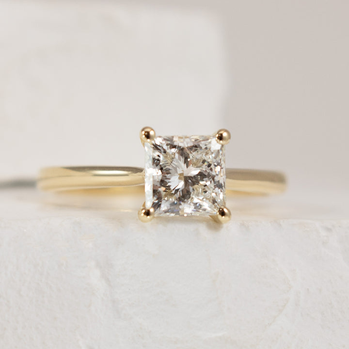 14KY Princess Cut 1.26CT Diamond Engagement Ring  

14K Yellow Gold Princess Cut Lab Grown Diamond Solitaire Engagement Ring 

Center Diamond - 1.26 Carat Princess Cut Lab Grown Diamond of 
VS1 Clarity, F Colour, Excellent/ Excellent Cut, IGI Ce