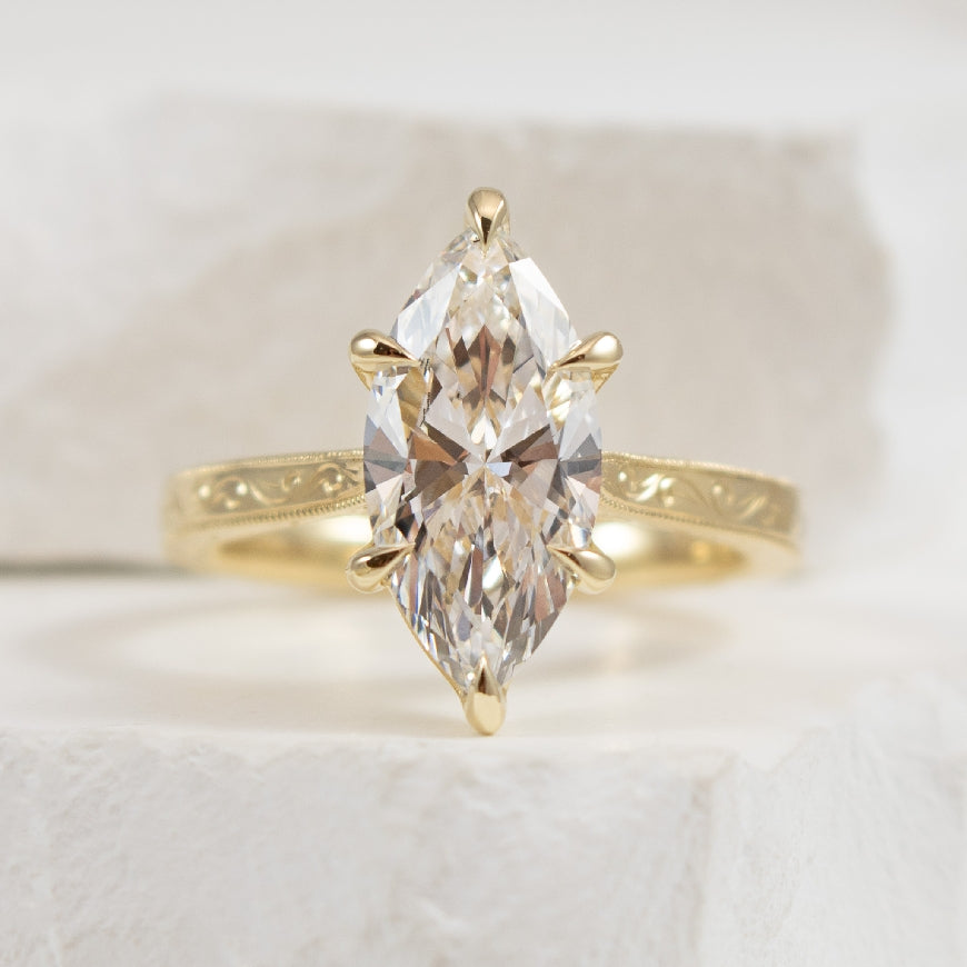 14KY Marquise Cut Diamond Engagement Ring       

14K Yellow Gold Gabriel & Co. Lab Grown Carved Solitaire Engagement Ring 

Center: 2.50 Carat Marquise Cut Lab Grown Diamond or VVS2 Clarity, F Colour, Excellent/ Excellent Cut, IGI Certified

F