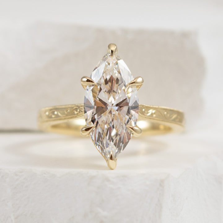 14KY Marquise Cut Diamond Engagement Ring       

14K Yellow Gold Gabriel & Co. Lab Grown Carved Solitaire Engagement Ring 

Center: 2.50 Carat Marquise Cut Lab Grown Diamond or VVS2 Clarity, F Colour, Excellent/ Excellent Cut, IGI Certified

F