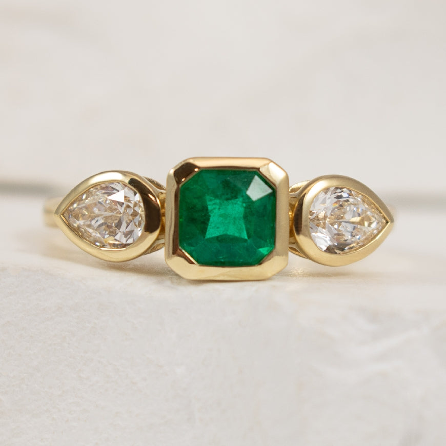 14KY Emerald & Diamond Bezel Set Three Stone Ring 

14K Yellow Gold Emerald & Canadian Diamond Bezel Set Three Stone Ring

0.59 Carat of Square Radiant Cut Emerald 

0.60 Total Canadian Diamond Weight of VS2 Clarity, F Colour, Very Good Cut 
(