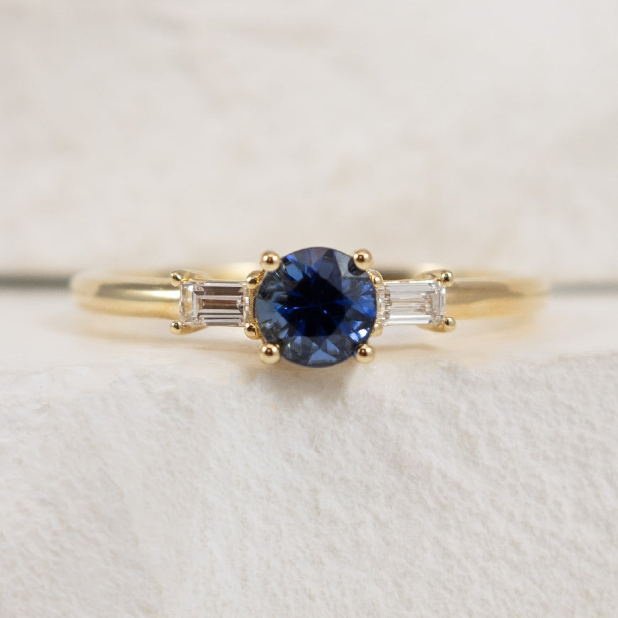 14KY Sapphire & Diamond Three Stone Ring 

14K Yellow Gold Natural Diamond & AAA Sapphire Three Stone Ring 

0.55 Carat Natural AAA Grade Blue Sapphire 

0.12TDW Baguette Cut Natural Diamonds of SI2-3 Clarity & GH Colour 

Finger Size 7 