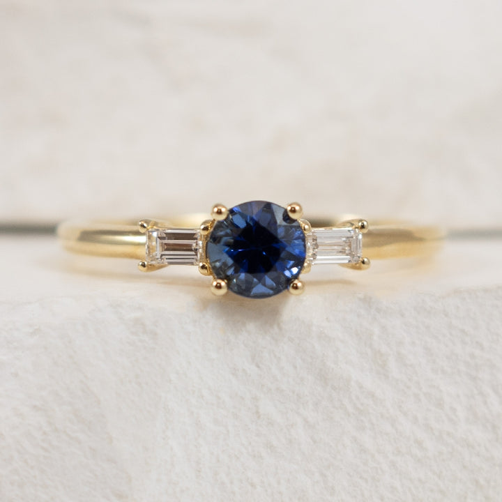 14KY Sapphire & Diamond Three Stone Ring 

14K Yellow Gold Natural Diamond & AAA Sapphire Three Stone Ring 

0.55 Carat Natural AAA Grade Blue Sapphire 

0.12TDW Baguette Cut Natural Diamonds of SI2-3 Clarity & GH Colour 

Finger Size 7 