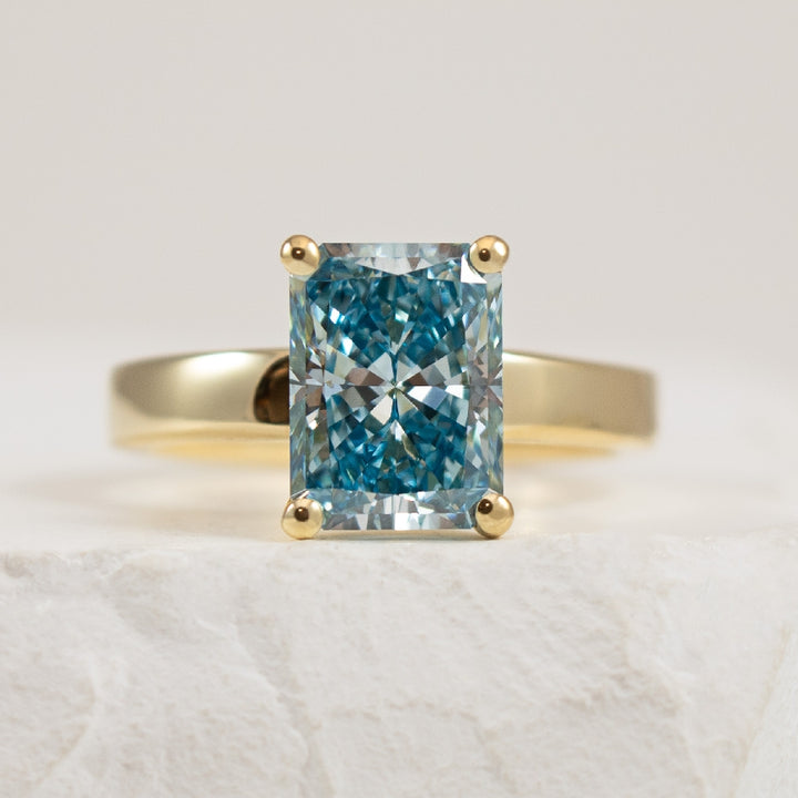 14KY Fancy Vivid Blue Diamond Engagement Ring 

14K Yellow Gold Fancy Vivid Blue Lab Grown Diamond Solitaire Engagement Ring 

Center - 3.04 Carat Radiant Cut Fancy Vivid Blue Lab Grown Diamond of VVS2 Clarity, Excellent/ Excellent Cut, IGI Certi
