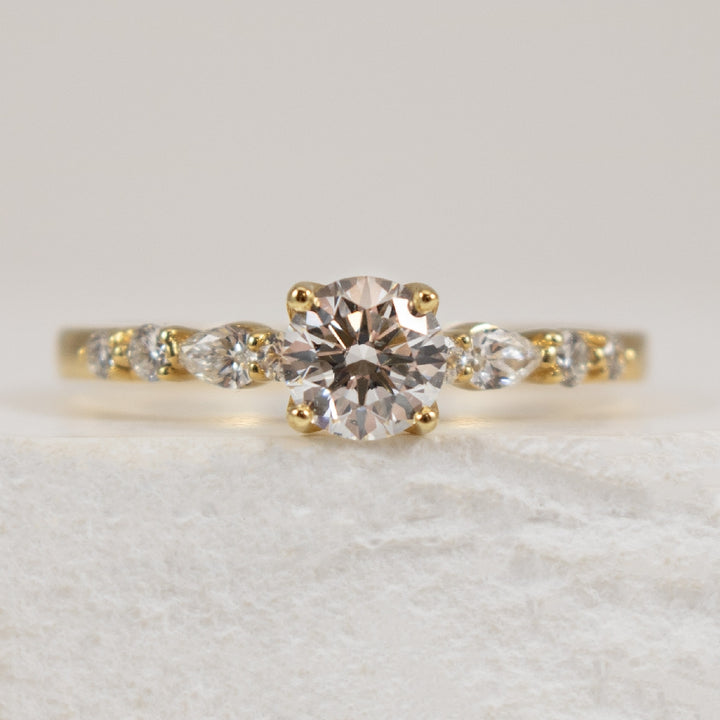 18KY 0.50CT Canadian Diamond Engagement Ring  

18K Yellow Gold Maple Lead Natural Diamond Accented Engagement Ring 

Center - 0.50 Carat Round Brilliant Cut Maple Leaf Canadian Natural Diamond of SI2 Clarity, E Colour, Very Good  

Accent Diam