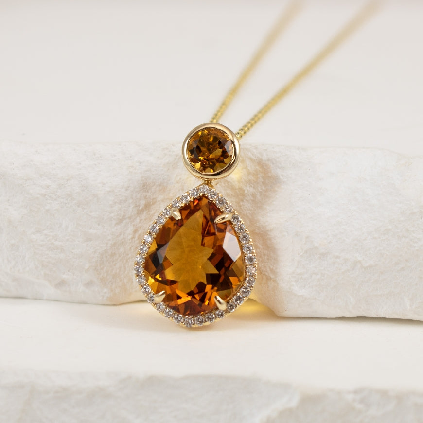 14KY Diamond & Citrine Necklace 

14K Yellow Gold Natural Diamond & Citrine Bezel & Halo Necklace

4.66 Carats Total Citrine Weight Round & Pear Cut 

0.16TDW SI Clarity, GH Colour 